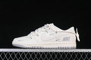 Nike SB Dunk Low Sneakers in Cream and Gray with Lace Details