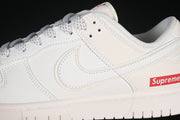 Nike SB Dunk Low Pro Supreme Sneakers in Cream and Red